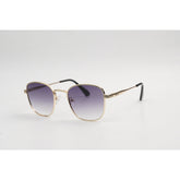 Sunglasses with gold frame and gradient lenses on a light gray background