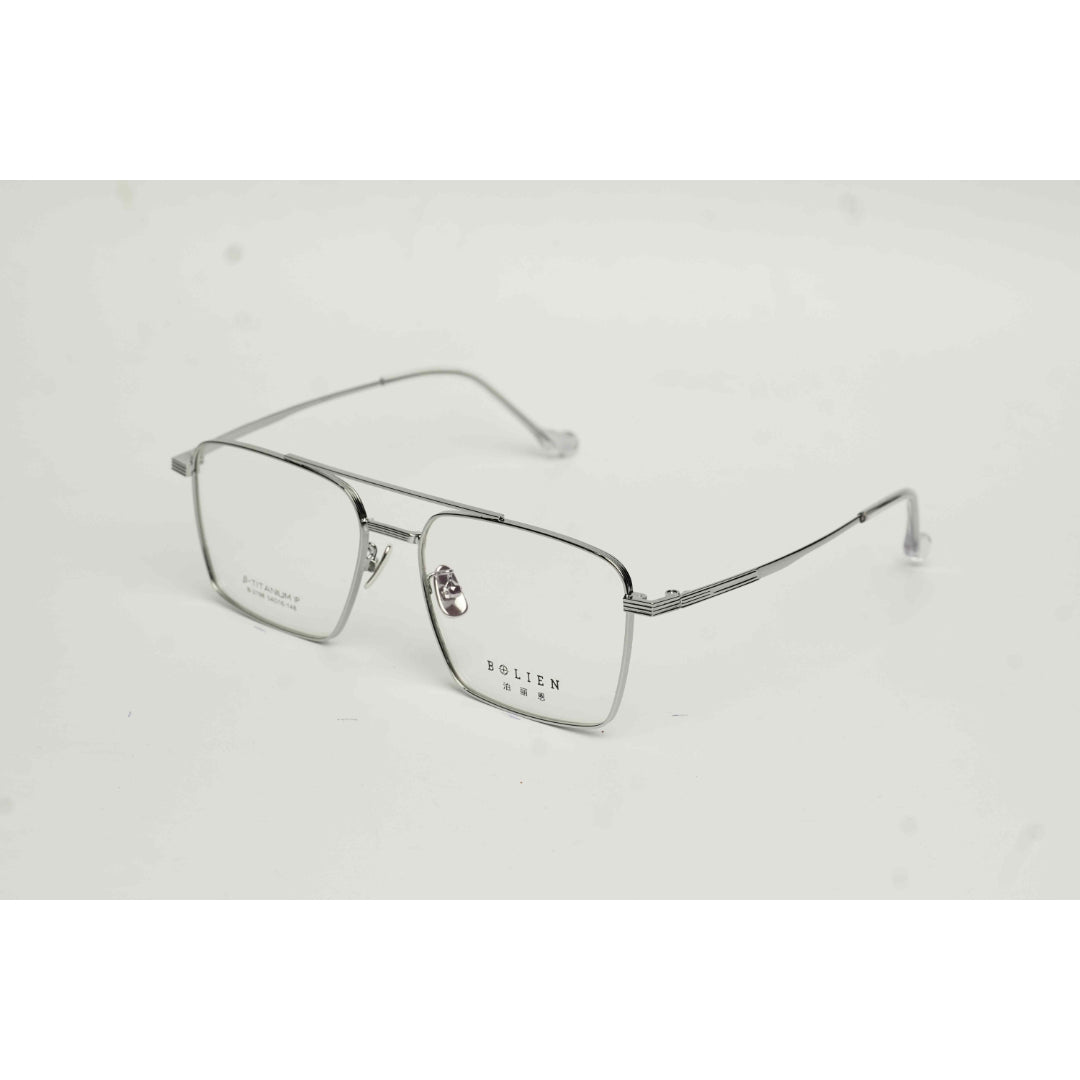 Silver eyeglasses on a light gray background